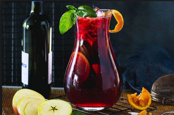 A Jar of Sangria with a Bottle of red wine