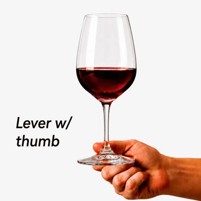 Holding a red wine glass using thumb support