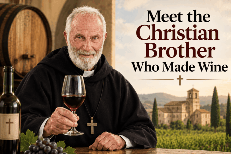 Brother Timothy in a traditional black Christian Brother habit holding a glass of red wine in a monastery vineyard, illustrating the story behind his contribution to winemaking.